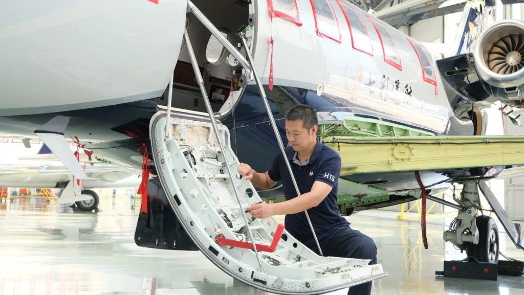 Yu Liqun performs maintenance checks on an Embraer Phenom 300 