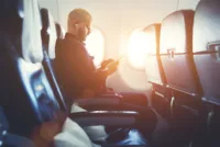 Man uses phone onboard aircraft