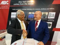 Kumar Balasingam and Rodolfo Baldascino shake on the agreement